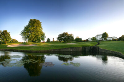 Lake on fairway at Druids Glen Golf Course with hole and bunker in background