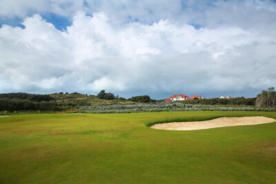 Hole with bunker at Le Touquet - La Mer Course with building in background