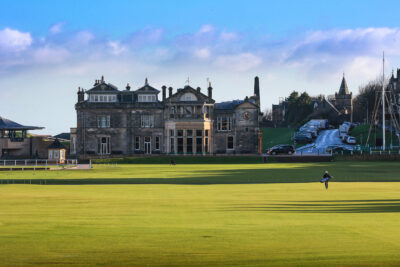 Fairway with old stone building in the background on a sunny day