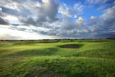 Hole with red flag with bunker at West Lancashire Golf Club