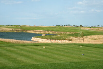 Tee box at Lighthouse Golf Course with a view of the lake and trees in the distance