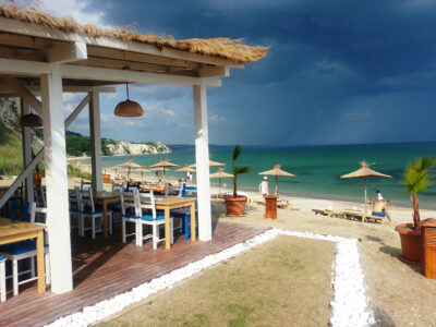 Beach bar and restaurant with ocean view and sun loungers