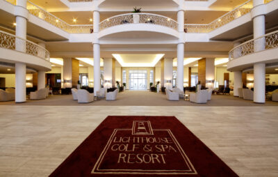 Reception area at Lighthouse Golf & Spa Resort with white pillars and seating areas