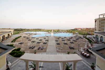 View of the outdoor pool at Lighthouse Golf Resort with black loungers around