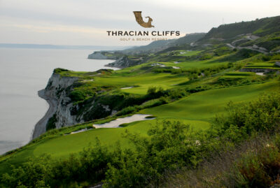 Cliff top golf course with bunkers overlooking the ocean with the Thracian Cliffs logo