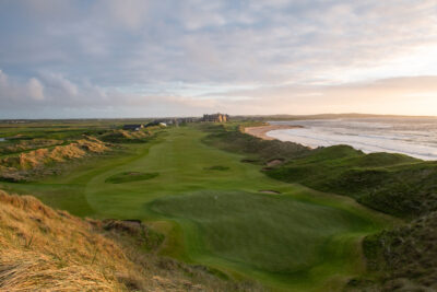 Hole with fairway and building in background at Trump International Golf Links - Doonbeg next to a beach