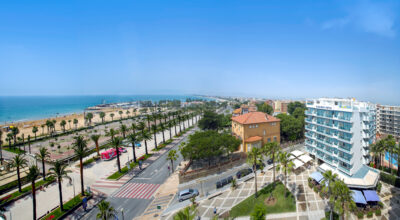 Exterior of Hotel Blaumar and surrounding buildings with a view of the beach