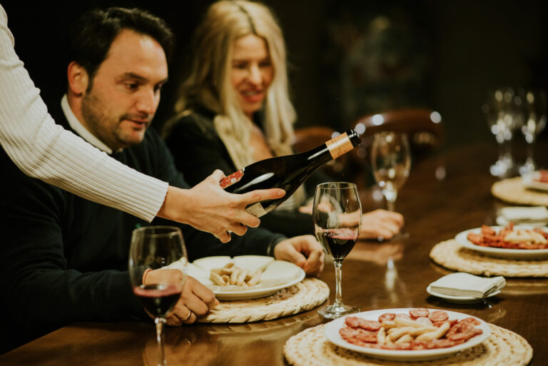 a couple sitting in a wine tasting