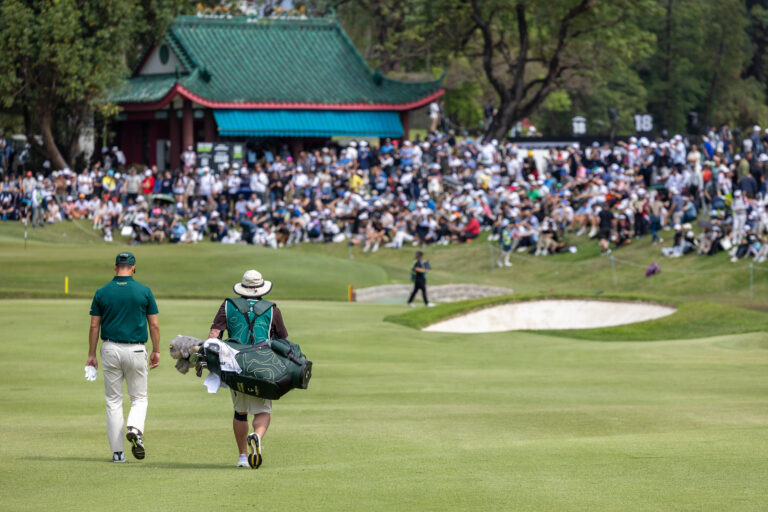 Martin Kaymer and caddie walk 10th hole at LIV Golf Hong Kong