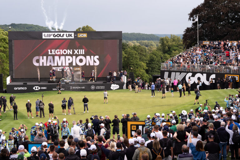 Legion XIII celebrare their victory on the podium at LIV Golf UK