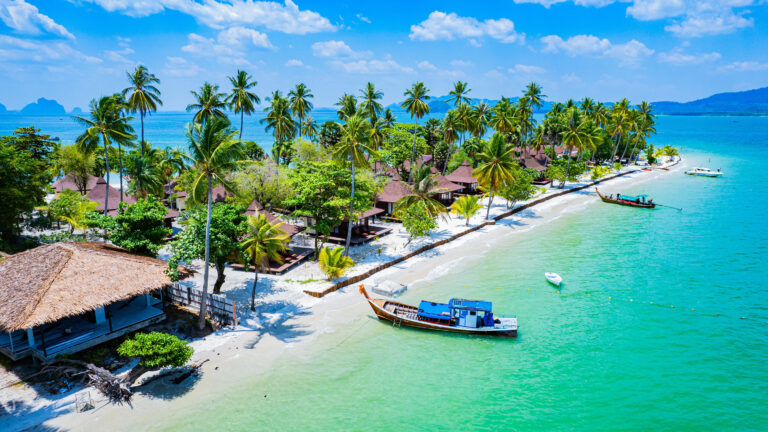 beachfront in Phuket Thailand with fisherman boats on the beach