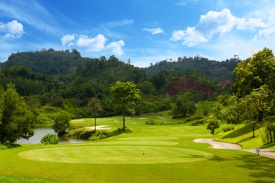 red mountain golf course green with trees in the background