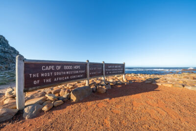 a sign with the name of the place at the beginning of a beach